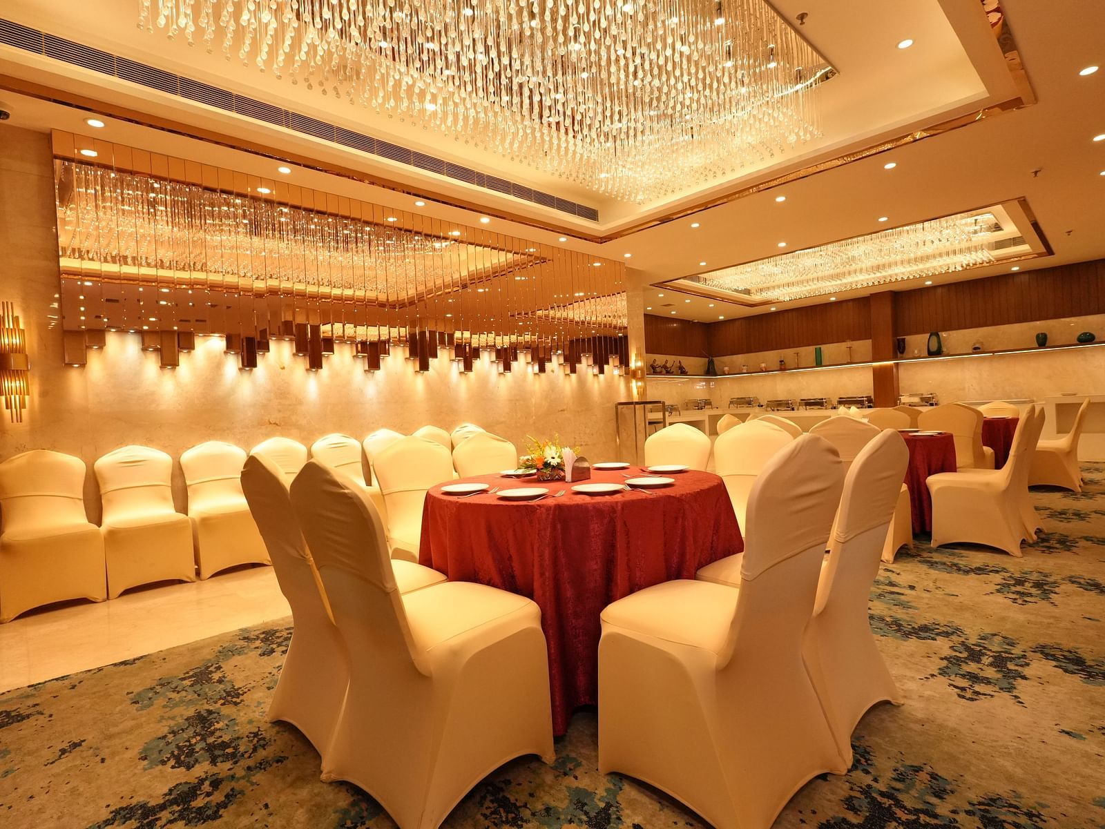 Spacious banquet room with chandelier and seating arrangement - Grand Plaza Lords Inn Jammu