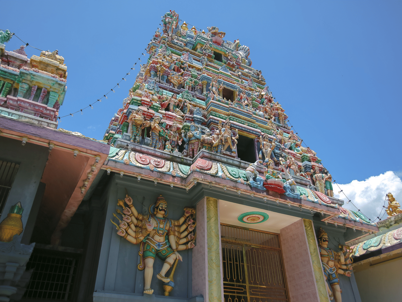 The exterior of a temple shrine taken from a lower angle against a plain blue-coloured sky.