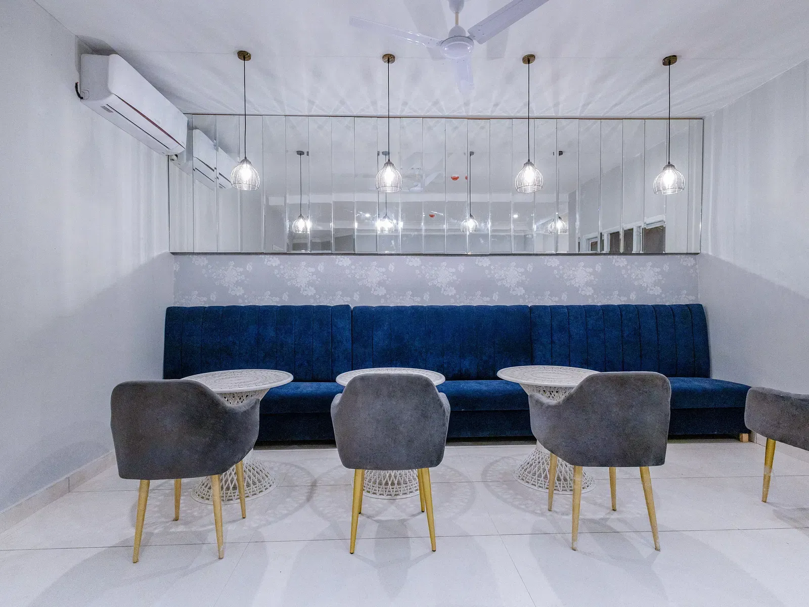 Restaurant area featuring modern chairs and tables against a dark blue wall. - Hotel Downtown17, Chandigarh 