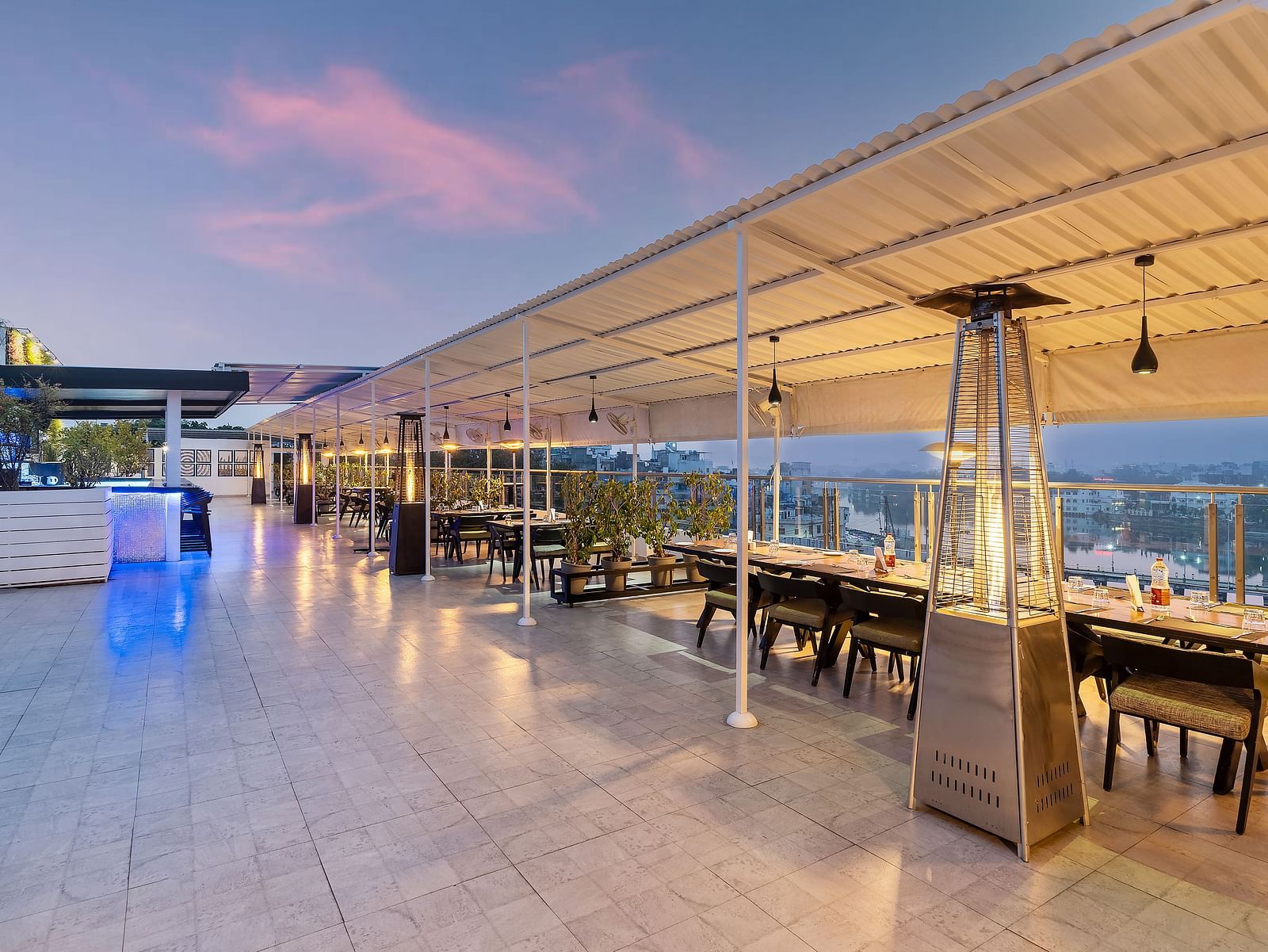 A wide angle shot of our rooftop restaurant in Udaipur with a backdrop of clear sky - Hotel Rajdarshan, Udaipur.