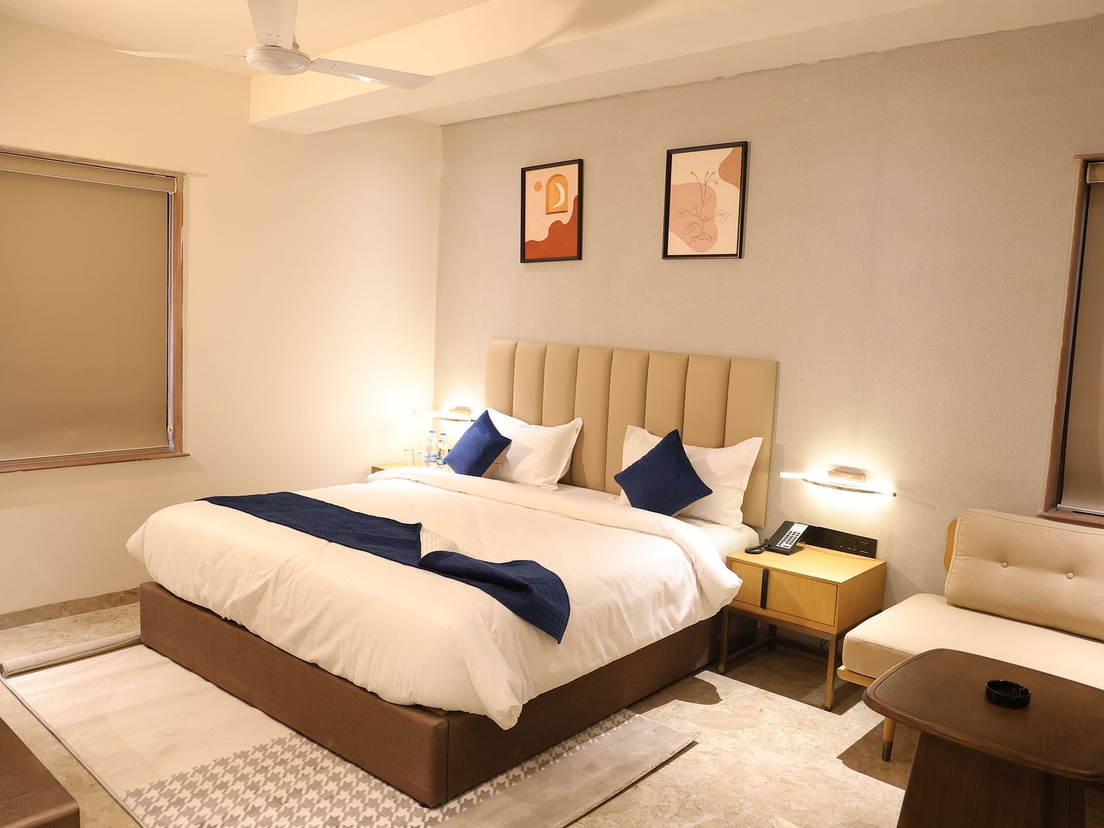 A luxurious Deluxe Room at Lords Eco inn Jamnagar Maheshwari Nagar showcasing a comfortable bed and contemporary furnishings.