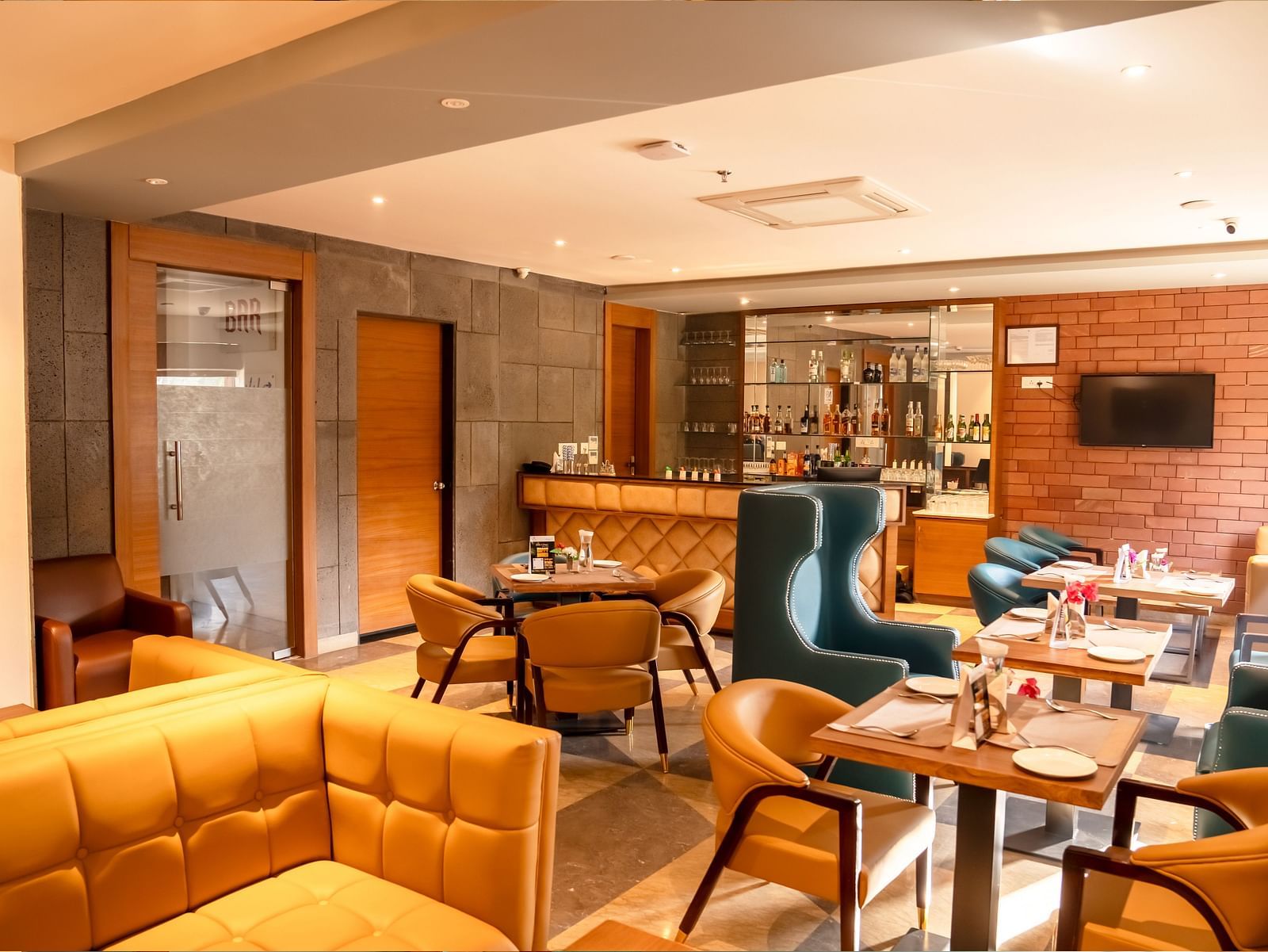 The Lords Inn Udaipur features a stylish dining area with a bar, comfortable seating, and modern decor.