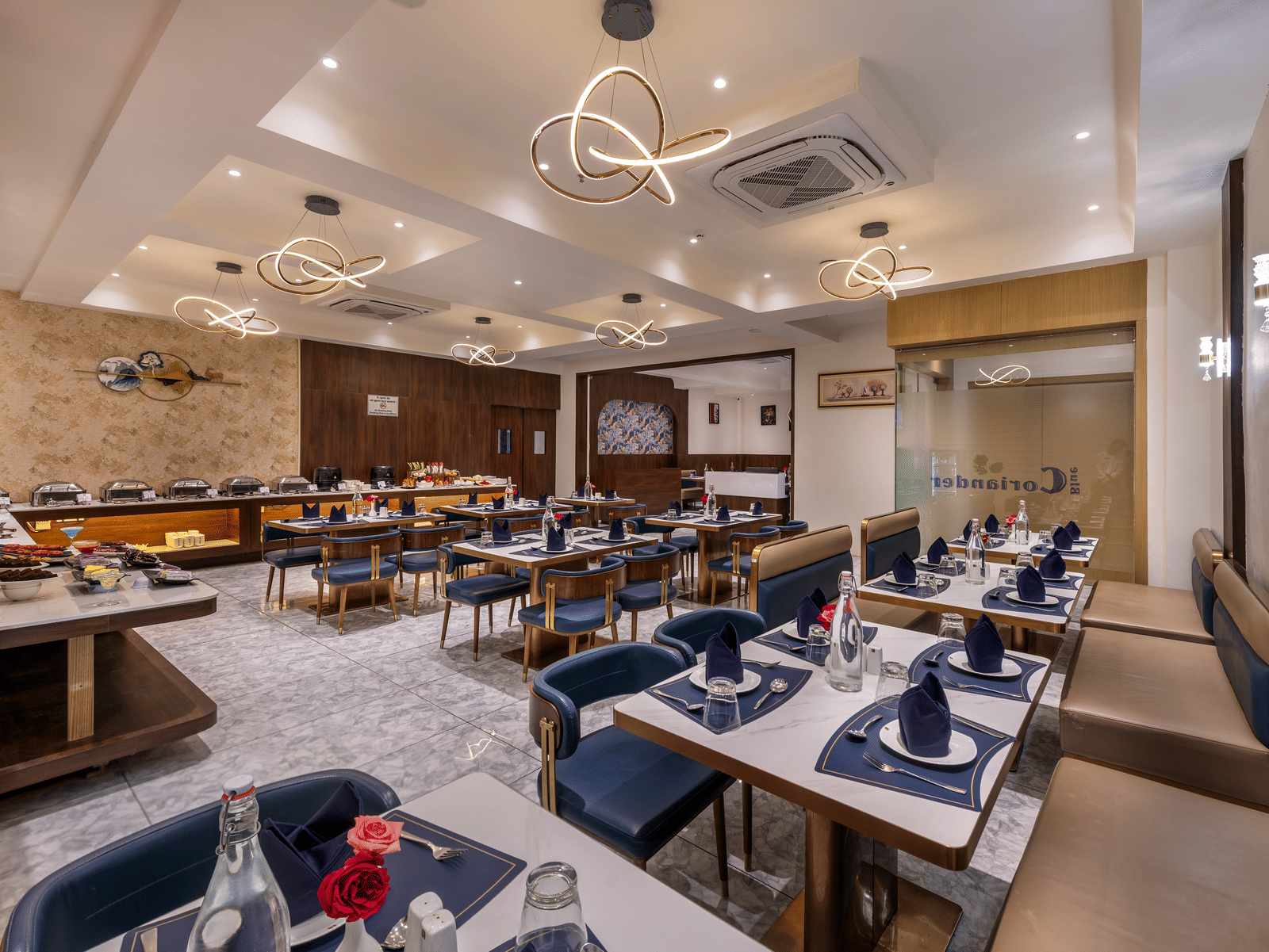 In-house dining area with neatly arranged tables and bright interiors at Lords Studio Inn, Jamnagar.