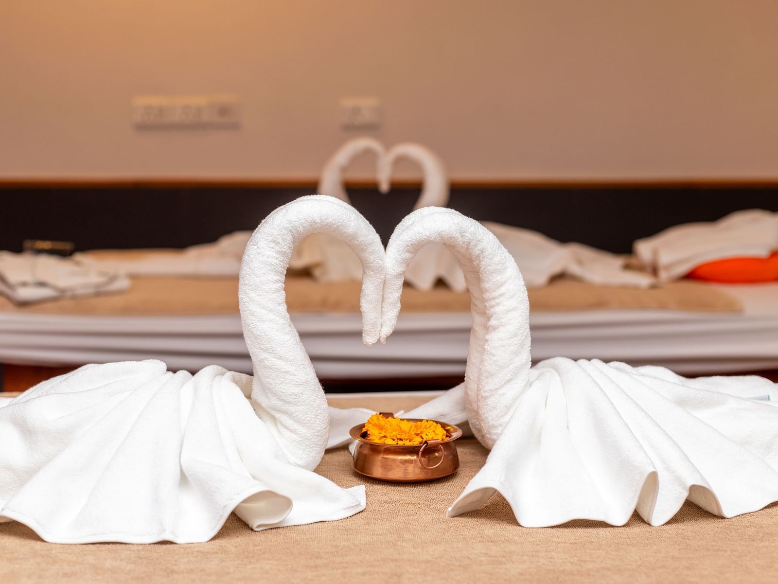 Two swan-shaped turkey towels placed to form a heart on a spa table at Mandala Norling Lords Prime in Kathmandu.