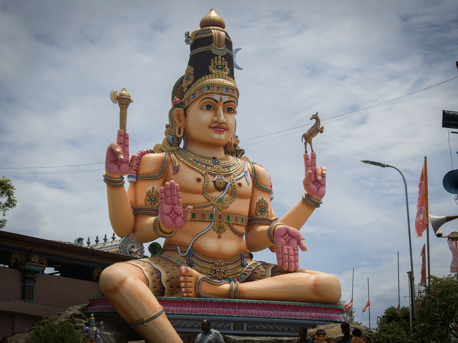 Large statue of Lord Shiva with a trident and drum.