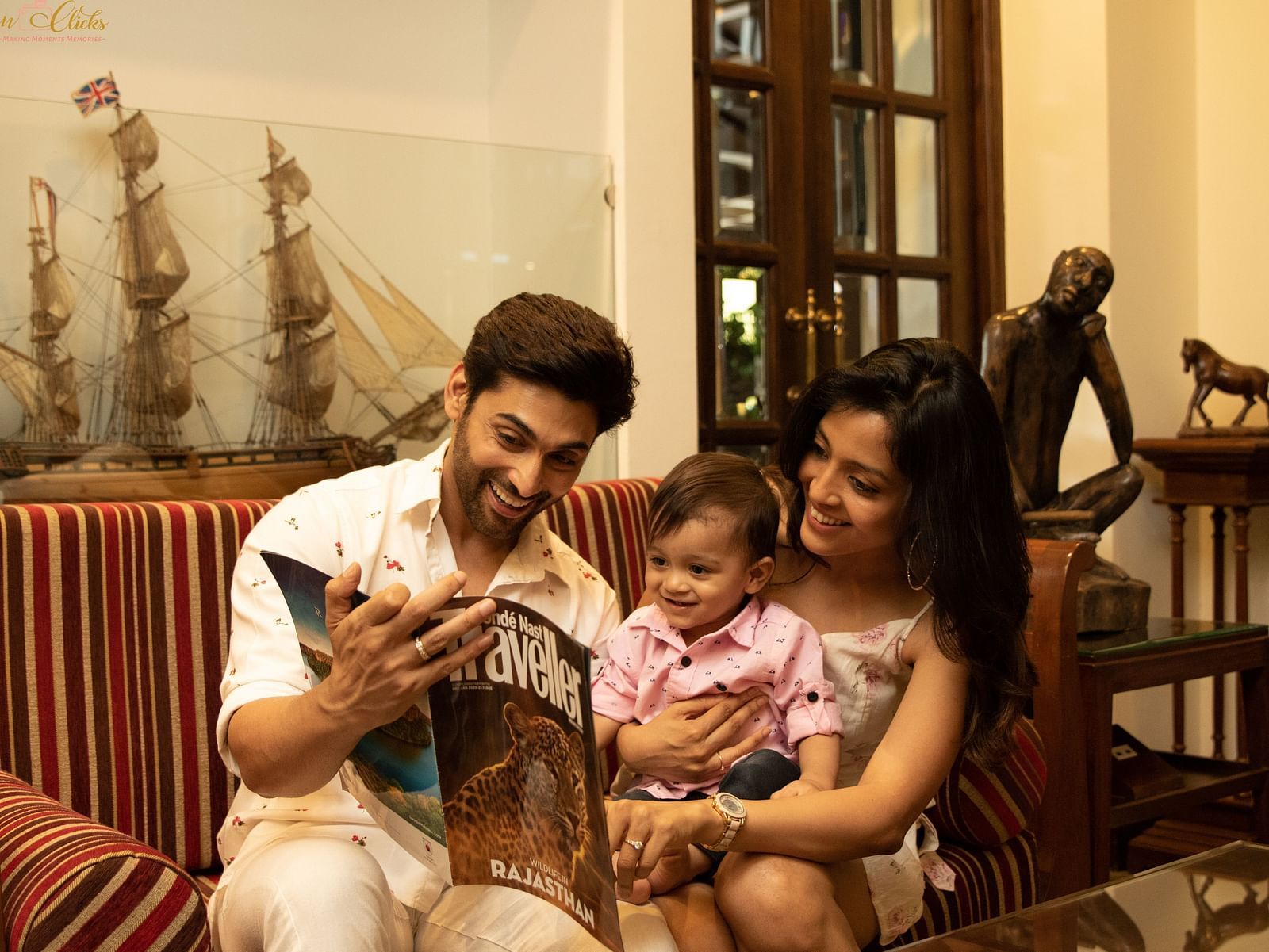 Parents amusing their kid with the Traveller magazine - Rhythm Lonavala
