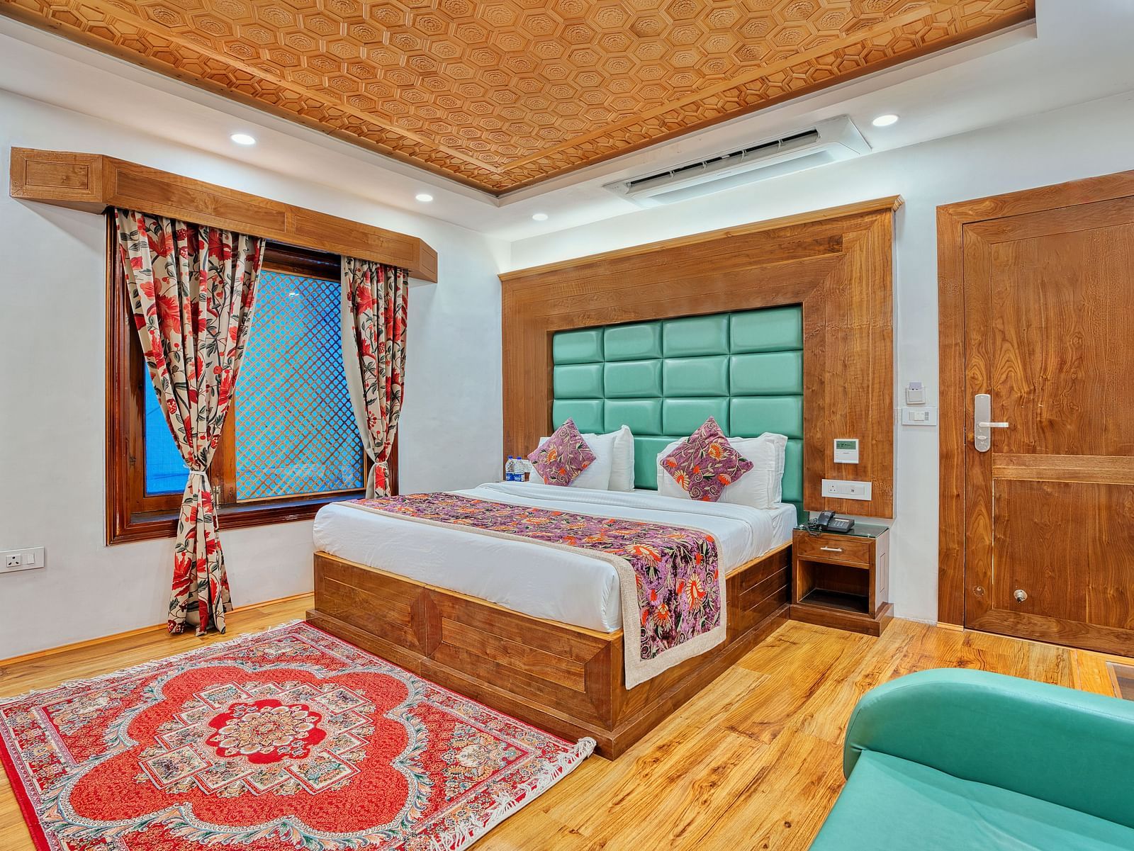 Cosy guest room with traditional decor and modern comfort at Royal Comfort Regency, designed for a peaceful and elegant stay.