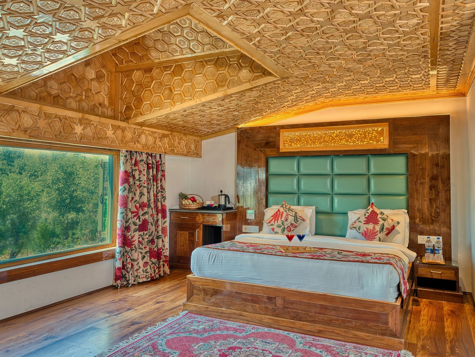 Sunlit room with lush outdoor views and refined design at Royal Comfort Regency, ideal for a refreshing retreat.