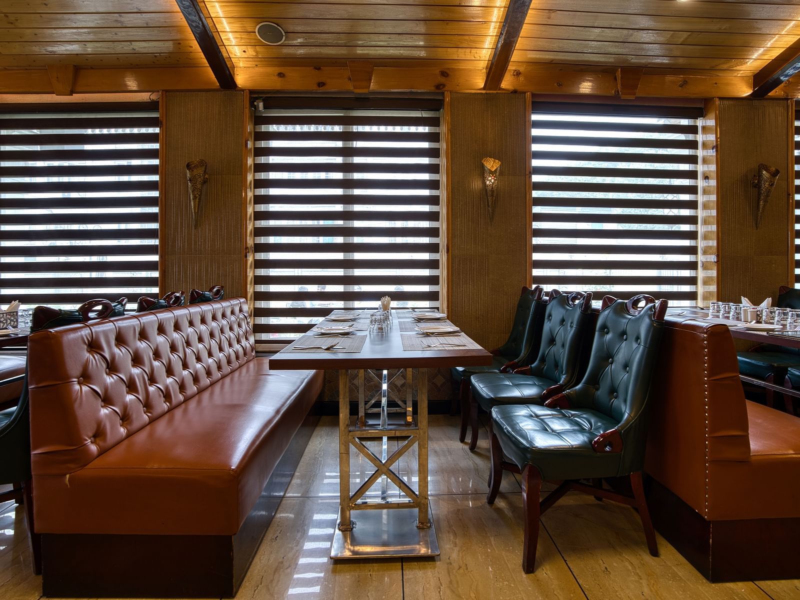 Private booth seating with natural light and modern decor at Royal Comfort Regency, ideal for intimate dining experiences.