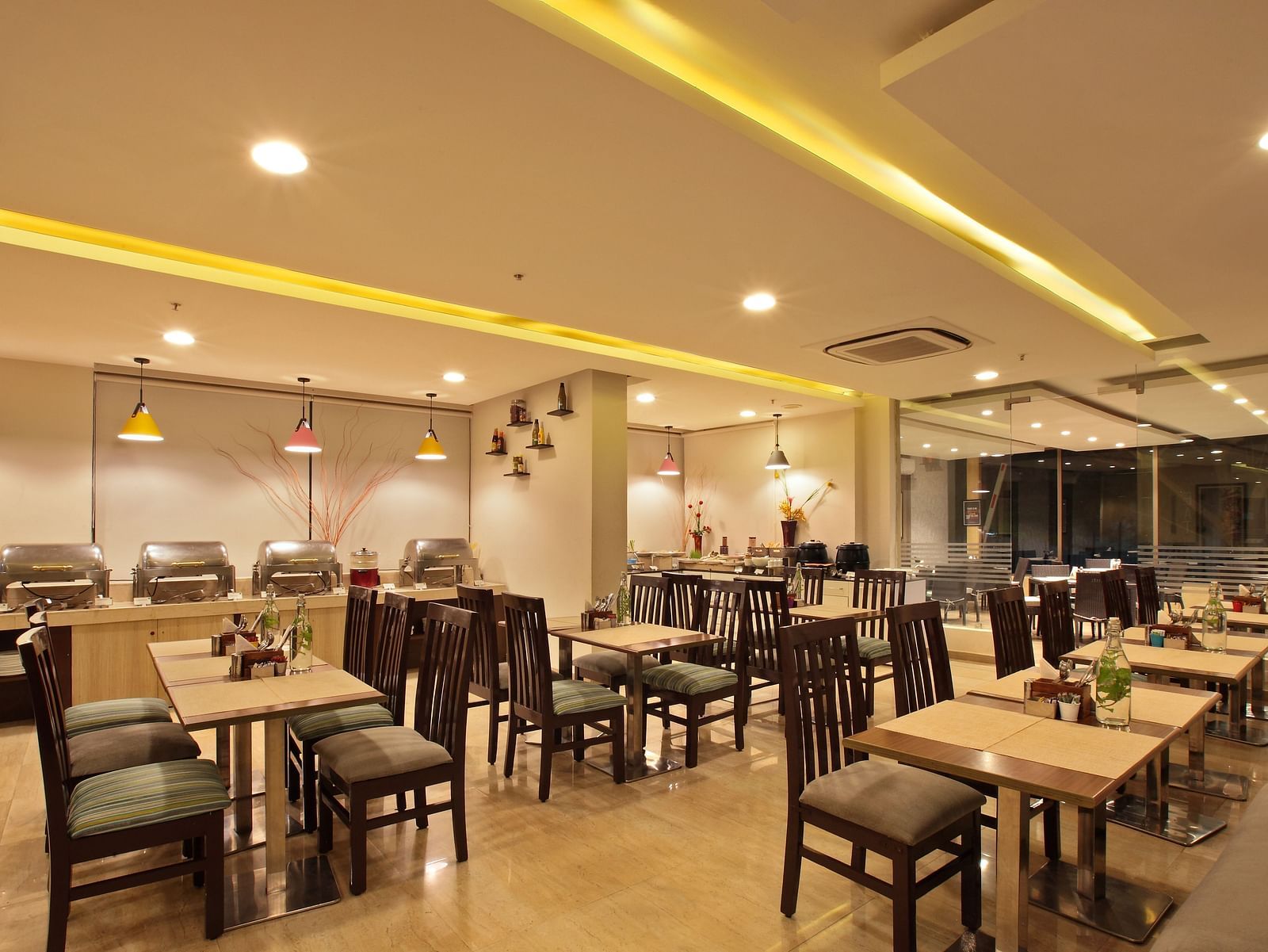 Seating arrangement in the restaurant at Starlit Suites, Bangalore