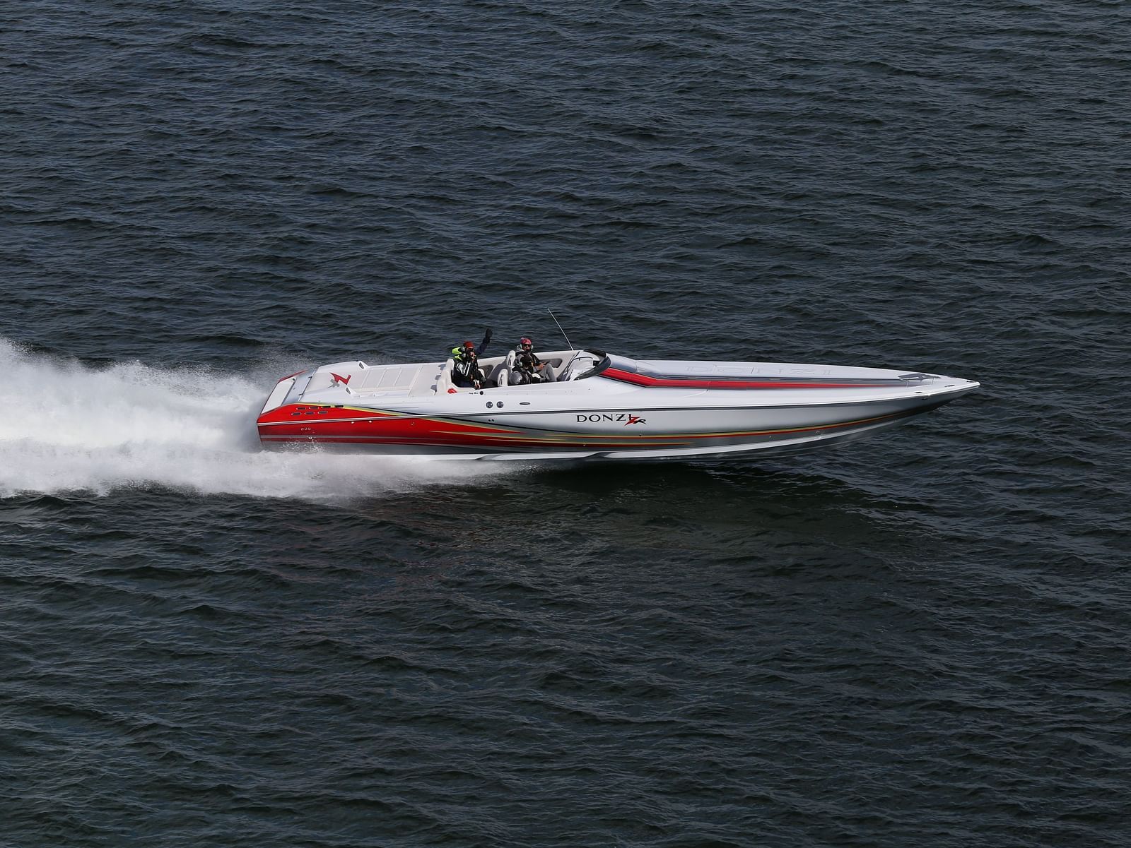 A person speed boating across a lake
