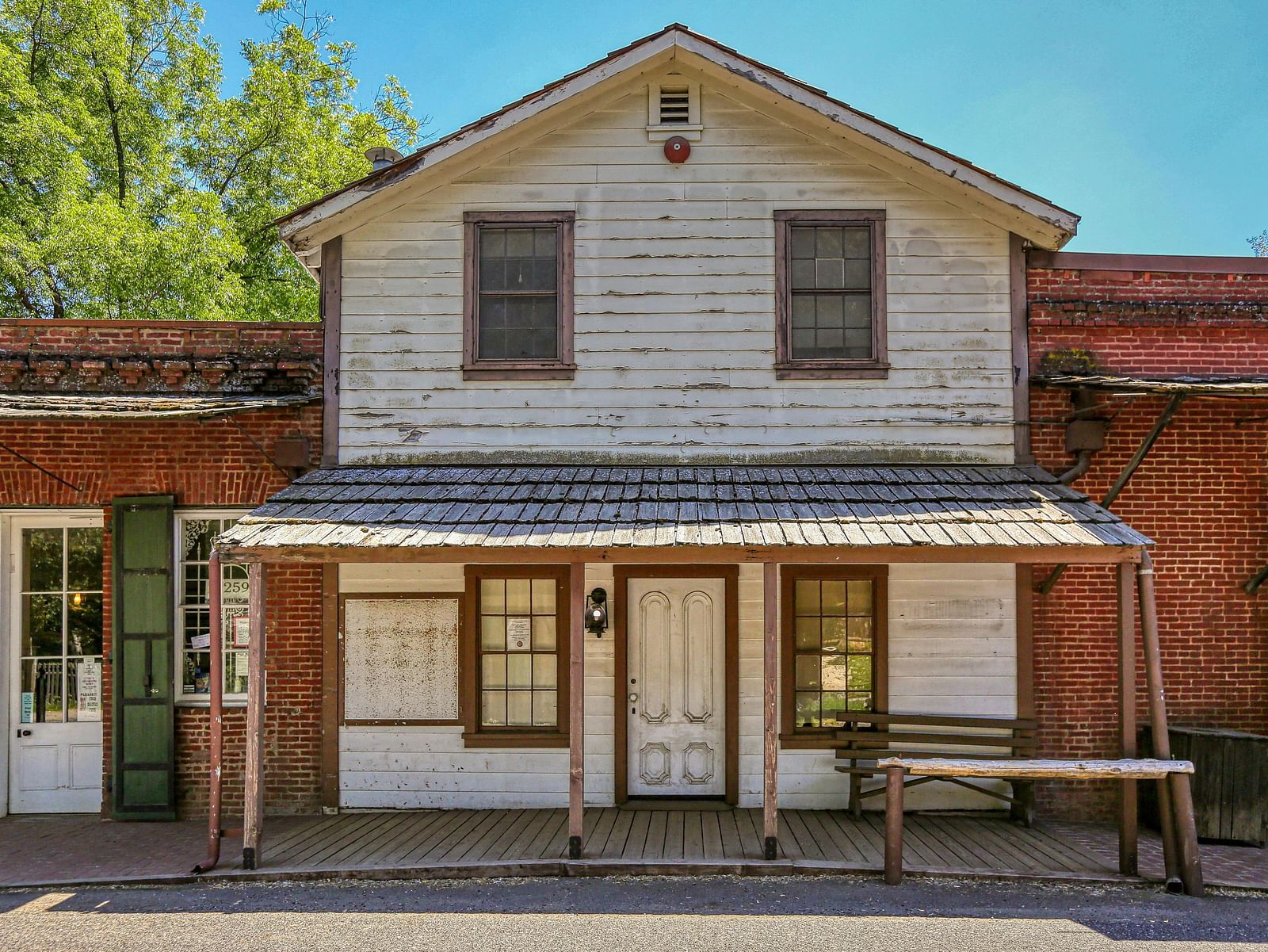 Exterior view of a rustic annex building with a front porch at The Groveland Hotel.