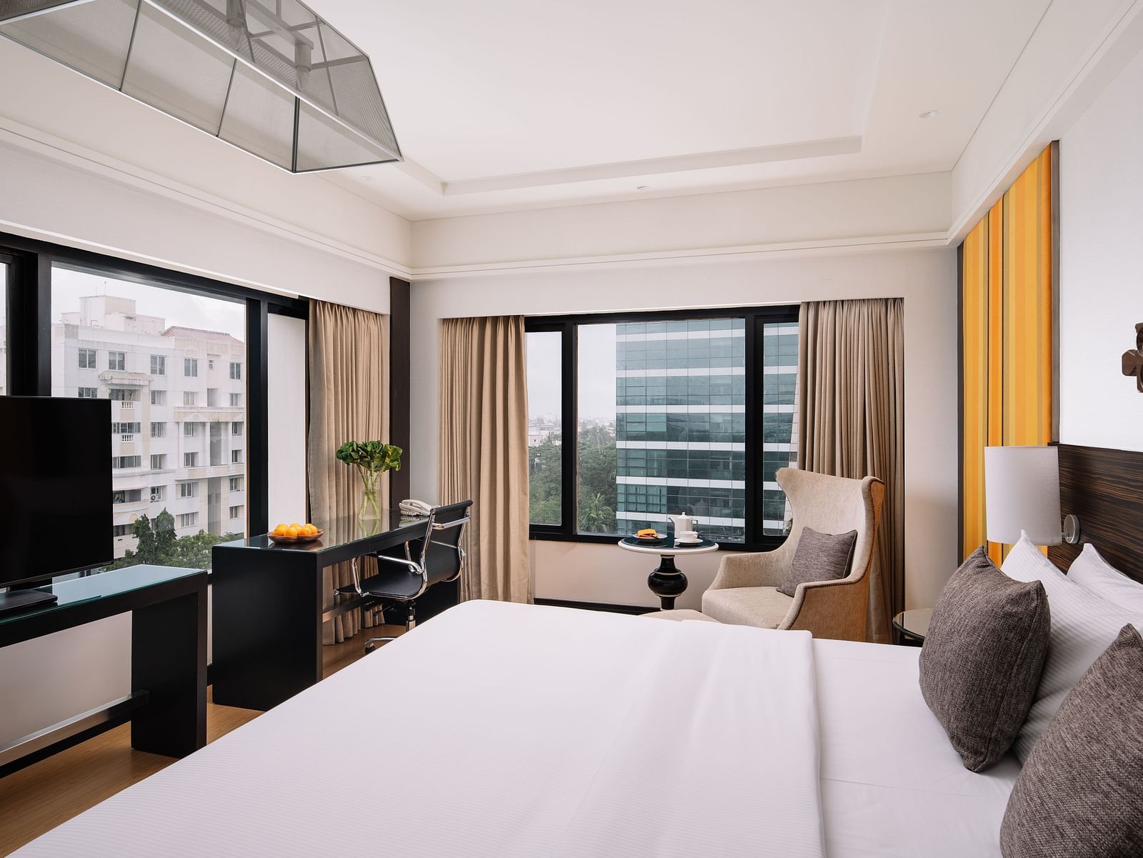 A bright, well-furnished bedroom with contemporary design and comfortable amenities at The Raintree, St. Mary's Road