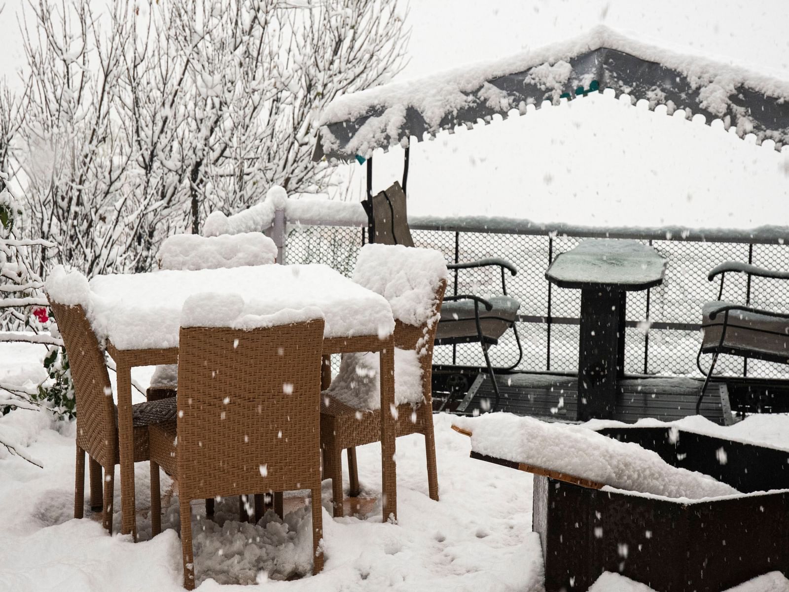 image of the outdoor seating area with a fire place in the foreground at the tattva, joshimath