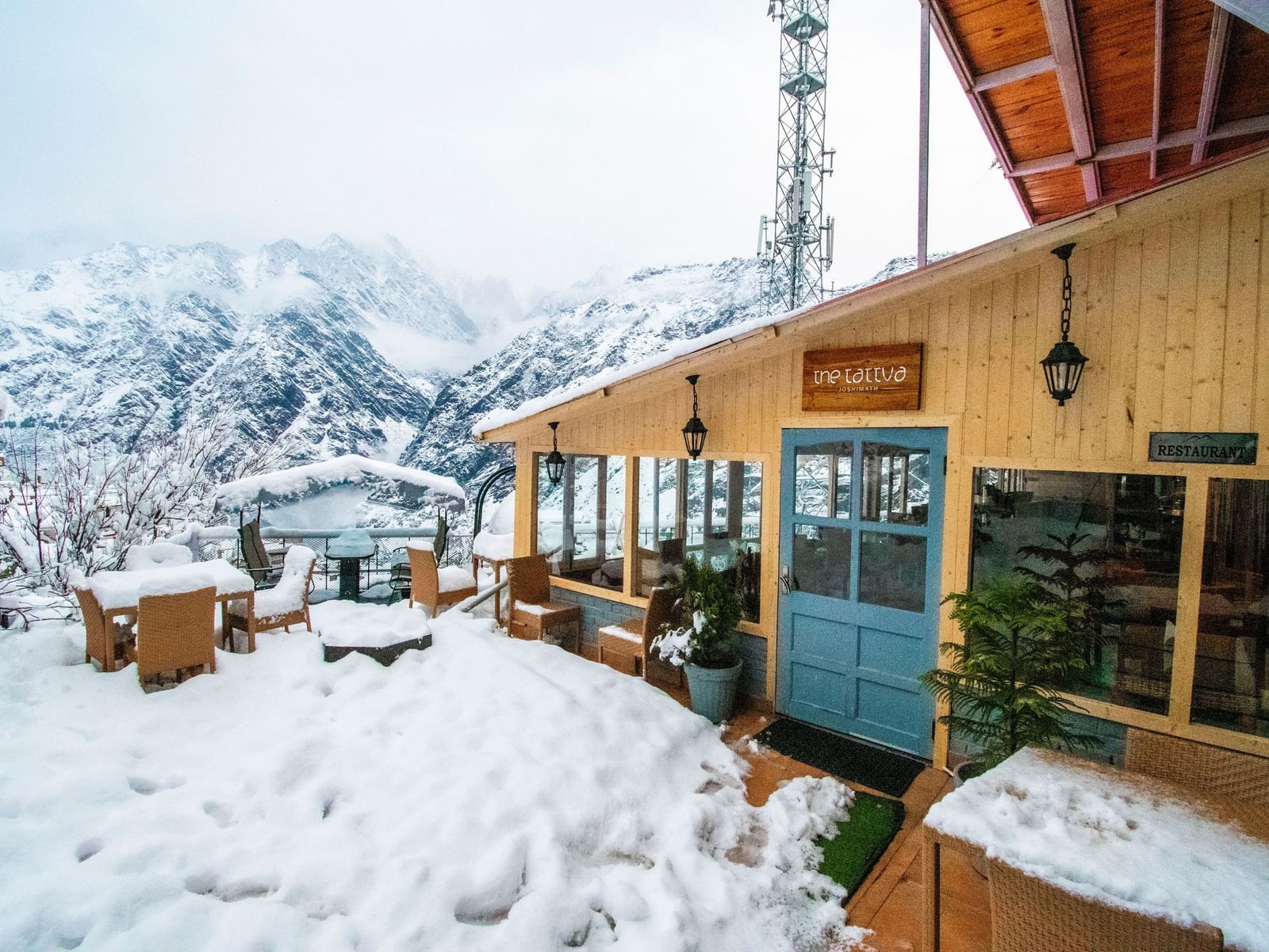 image of the tattva, joshimath featuring the outdoor dining area with a think blanket of white snow