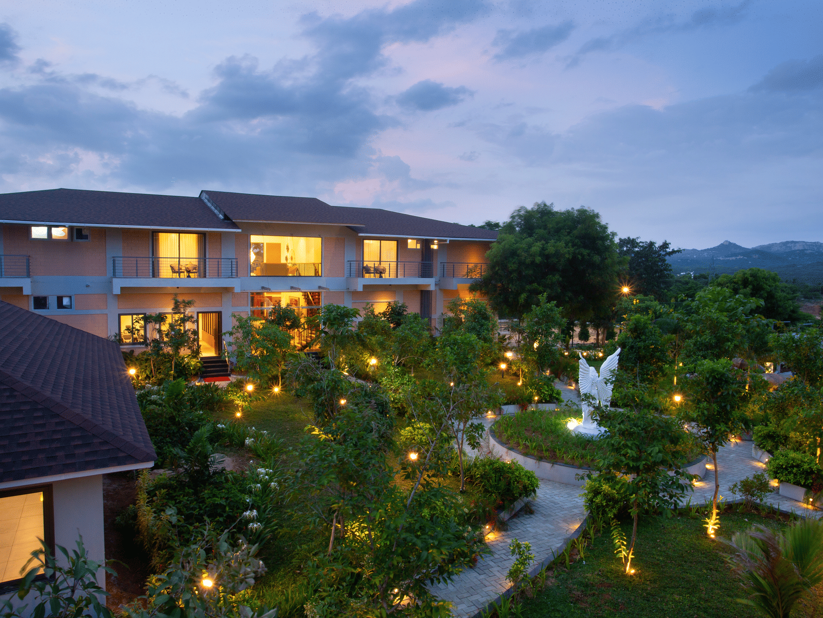 Facade of Trishvam Symphoony , Krishnagiri  with trees and trail path.