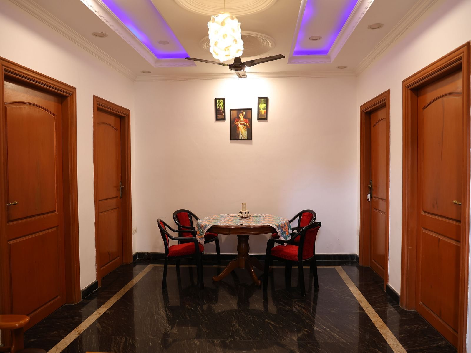 Image of a living room with a table and chairs around it at Villa Serenity Le Sejour, Pondicherry.