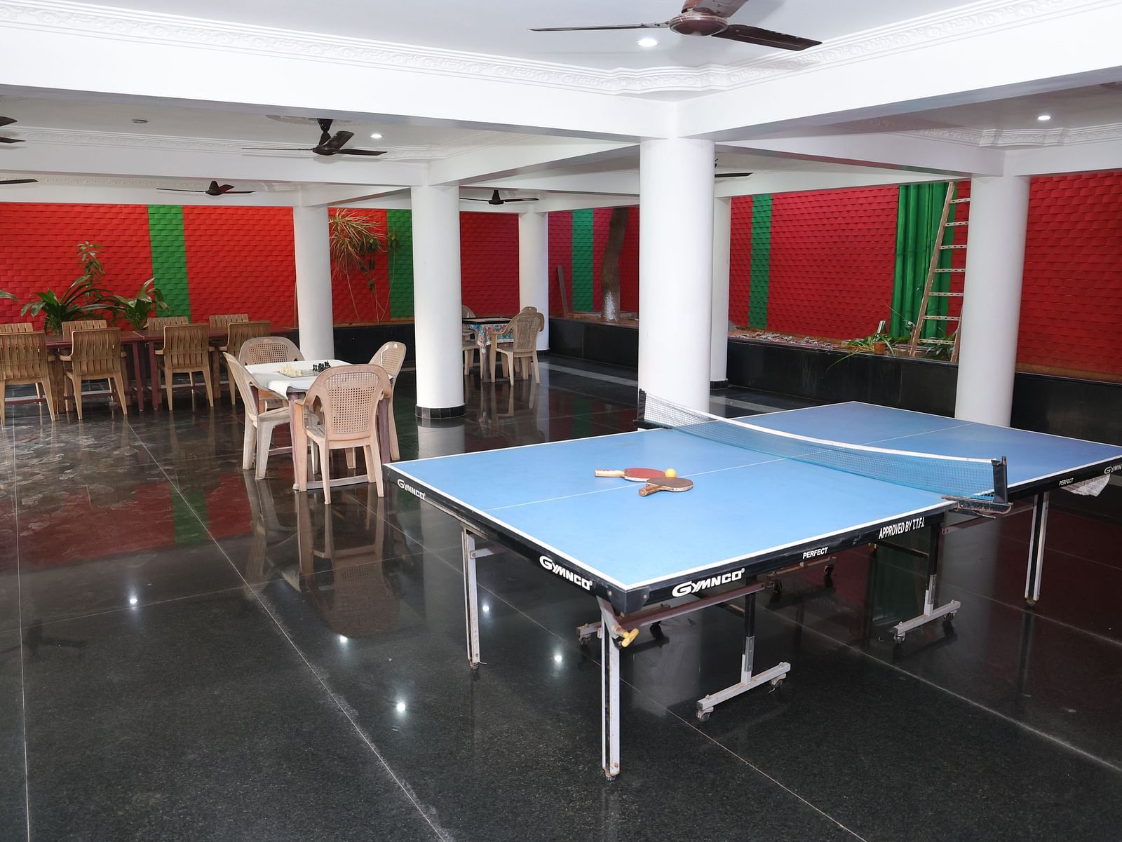 Image of a games zone with a table tennis board and chairs and tables in the background at Villa Serenity Le Sejour, Pondicherry.
