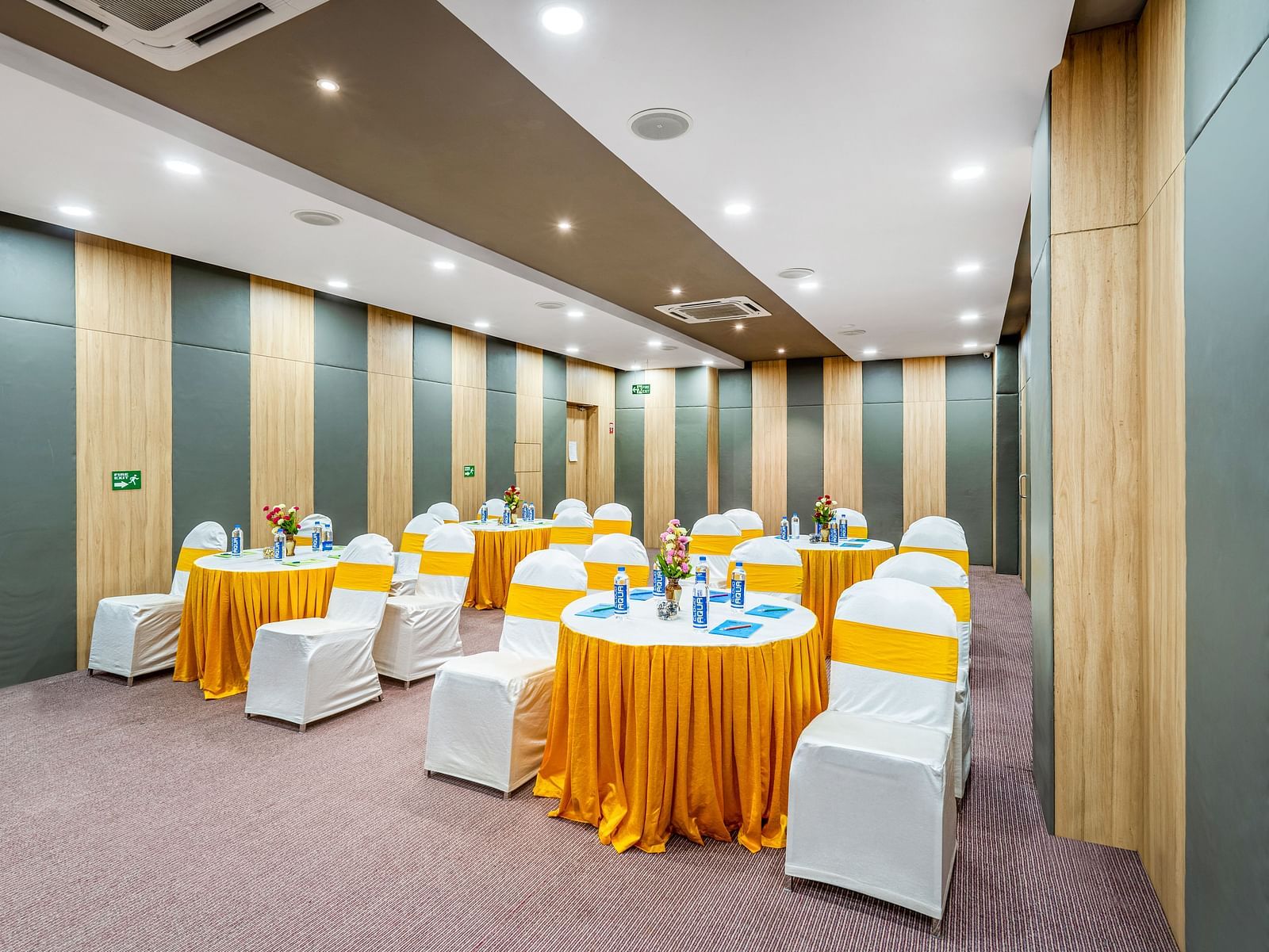 A well-furnished conference room displaying a table and chair at Westside Hotel Hitech City