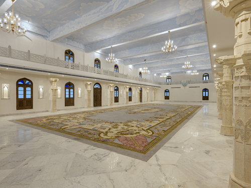 Fateh Vilas Udaipur - Interior view of the Surya Prakash hall with white decor and chandeliers