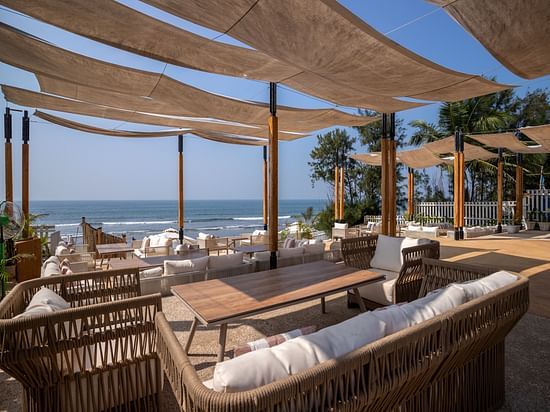 full view image of the saz on the beach restaurant at sibaya beach resort, morjim beach with covered seating arrangements