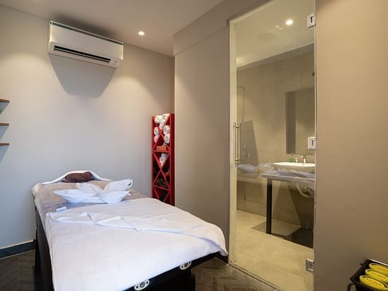image of the spa featuring an air conditioned room with a wide bed at sibaya beach resort, morjim beach