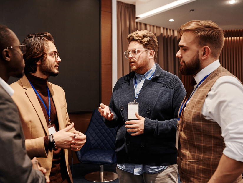 A diverse group of professionals engaged in a business meeting discussion indoors.