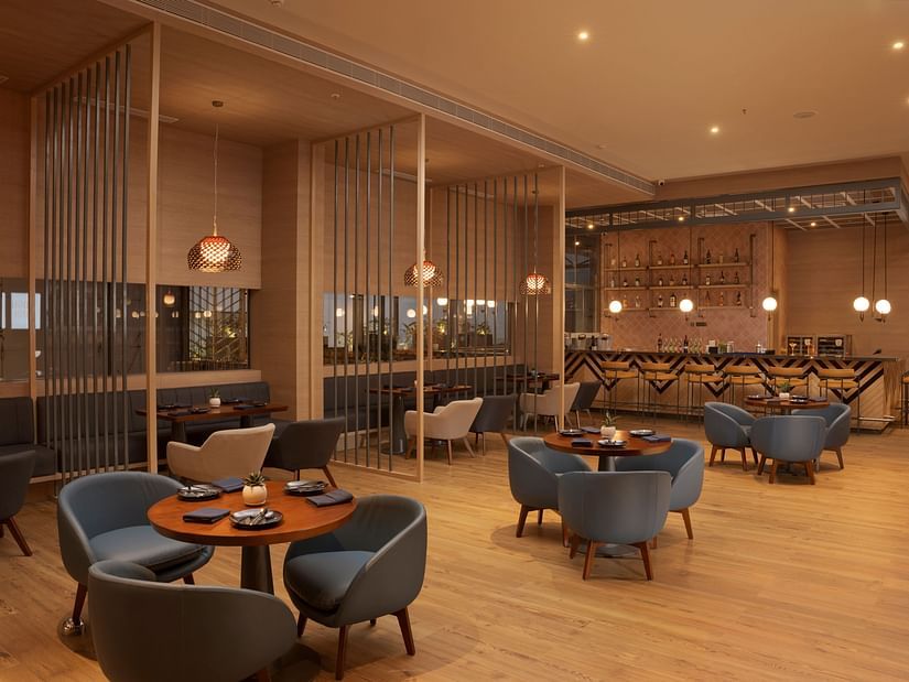 A stylish and modern dining space at High Dive Restaurant, featuring elegant seating, warm lighting, and a sophisticated bar area.