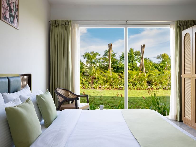 image of the bedroom of garden suite featuring the huge french windows with amazing views outside with ample natural light in the room
