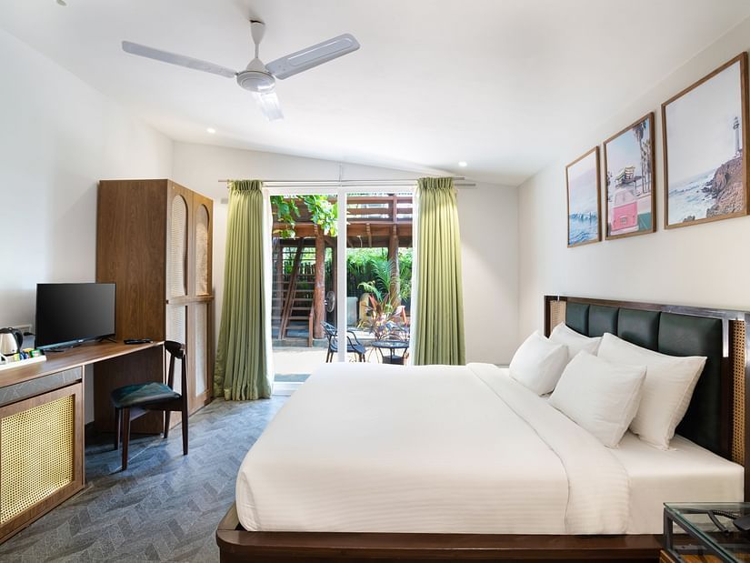 full view image of the tropical classic cottage with ample of natural light coming from the french windows at the far end of the room