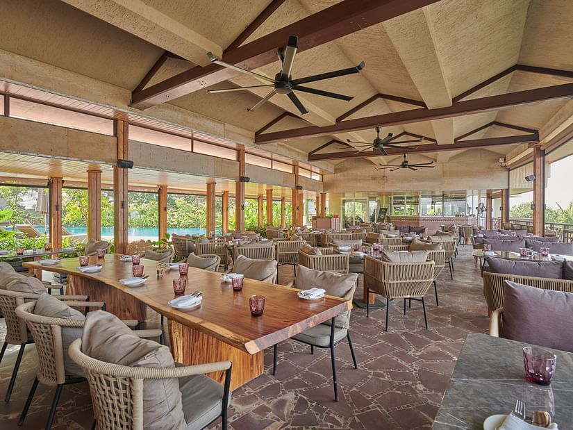Dining space by the swimming pool with ceiling fans at The Dukes Retreat