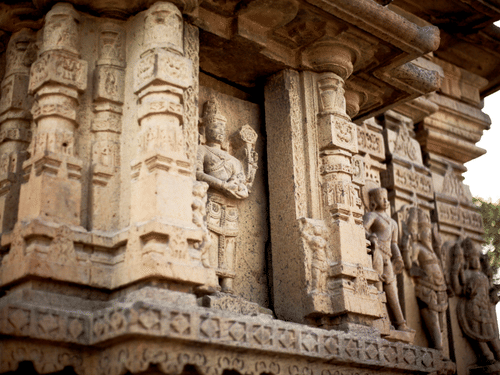 A close up of the intricate stone carvings showcasing many deities on Kedareshwara Temple in Halebidu.