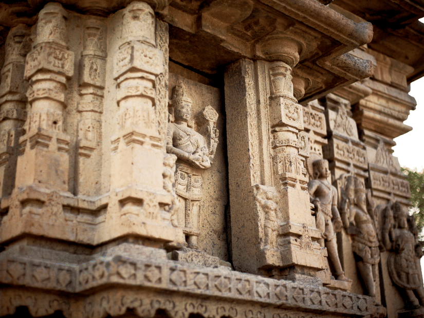 A close up of the intricate stone carvings showcasing many deities on Kedareshwara Temple in Halebidu.
