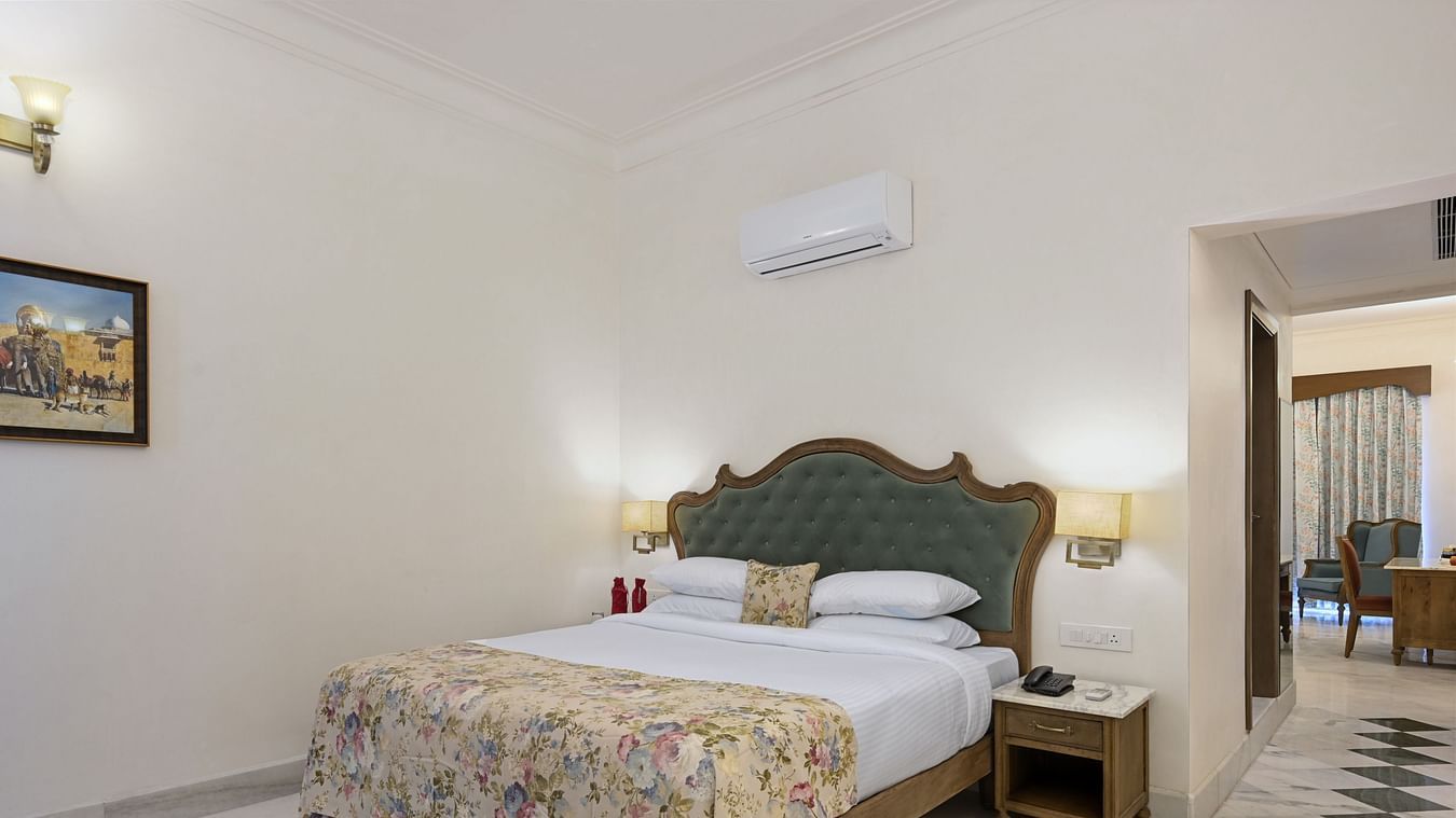 Fateh Vilas Udaipur - Interior view of the Family Plunge Suite featuring a king size bed an air conditioner and marble flooring