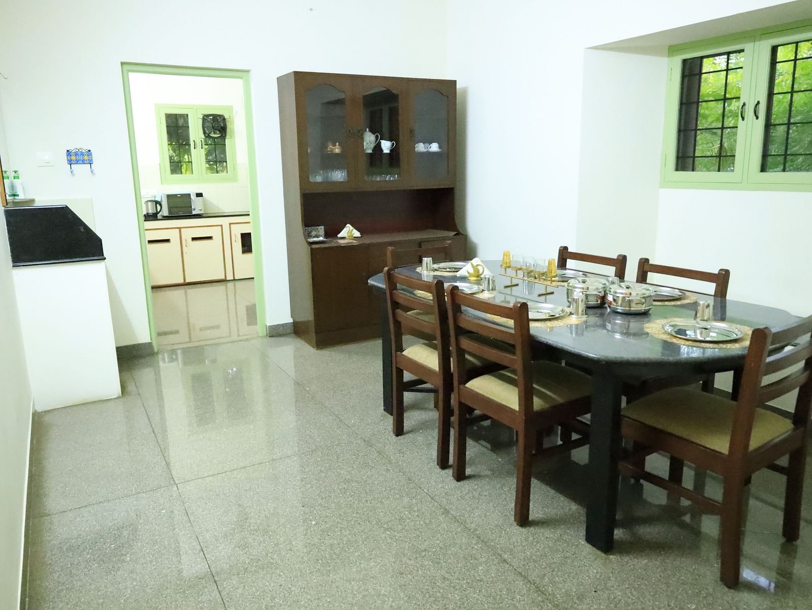 Image of the dining room with a table, chairs, and a cabinet.