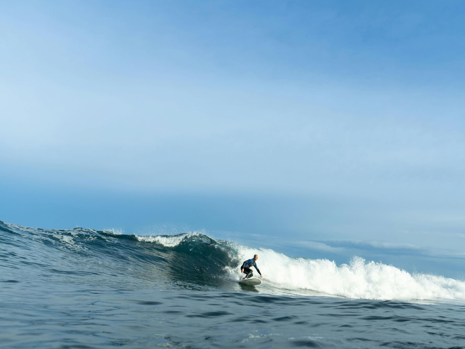 A surfer riding a wave in the sea.