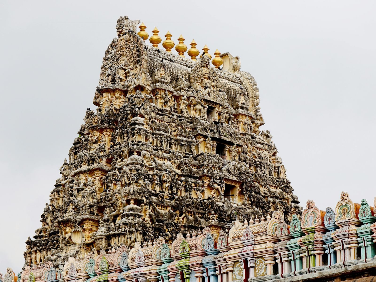 A towering, intricately carved stone temple reaching towards a light sky.