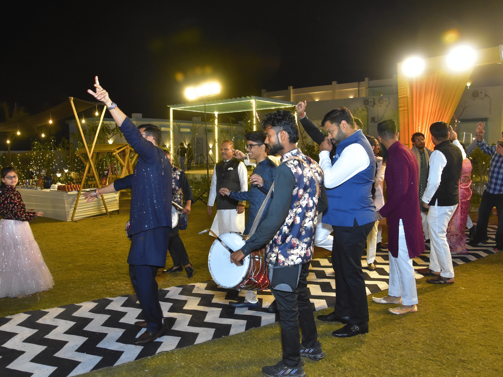 Guests dancing and celebrating under festive lights at Vedikant Resorts The Mallard Corbett.