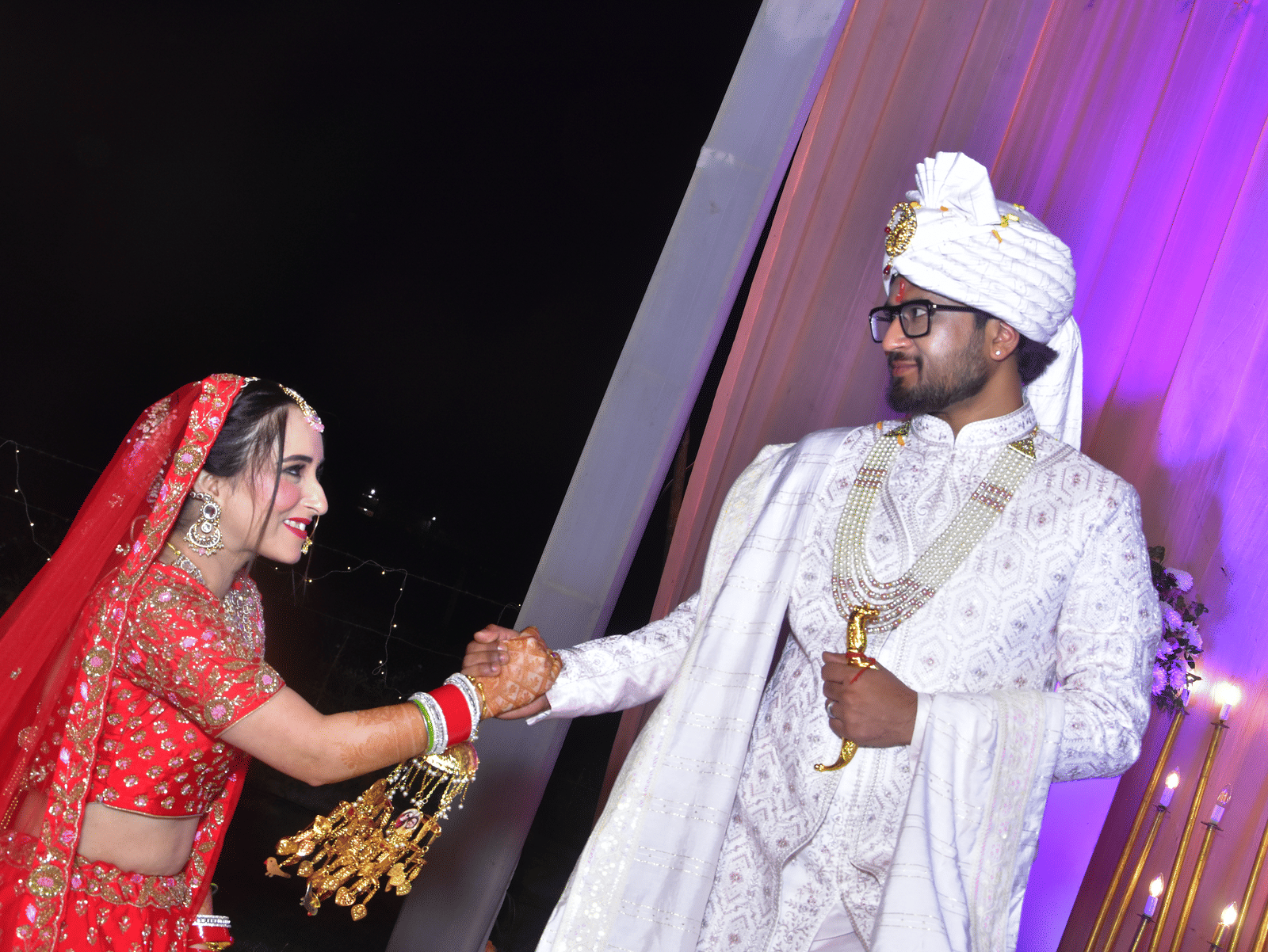 Couple share a joyful moment on the wedding stage at Vedikant Resorts The Mallard Corbett.