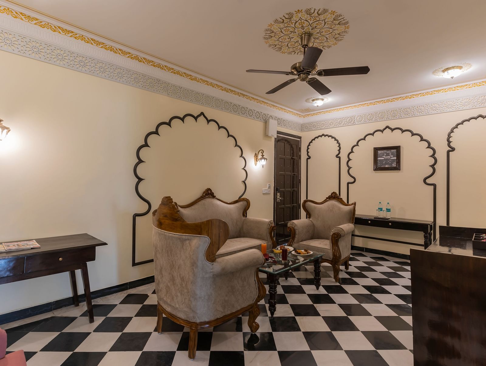 Royal-style living room with sofas and black-and-white flooring at Kesar Bagh Palace.
