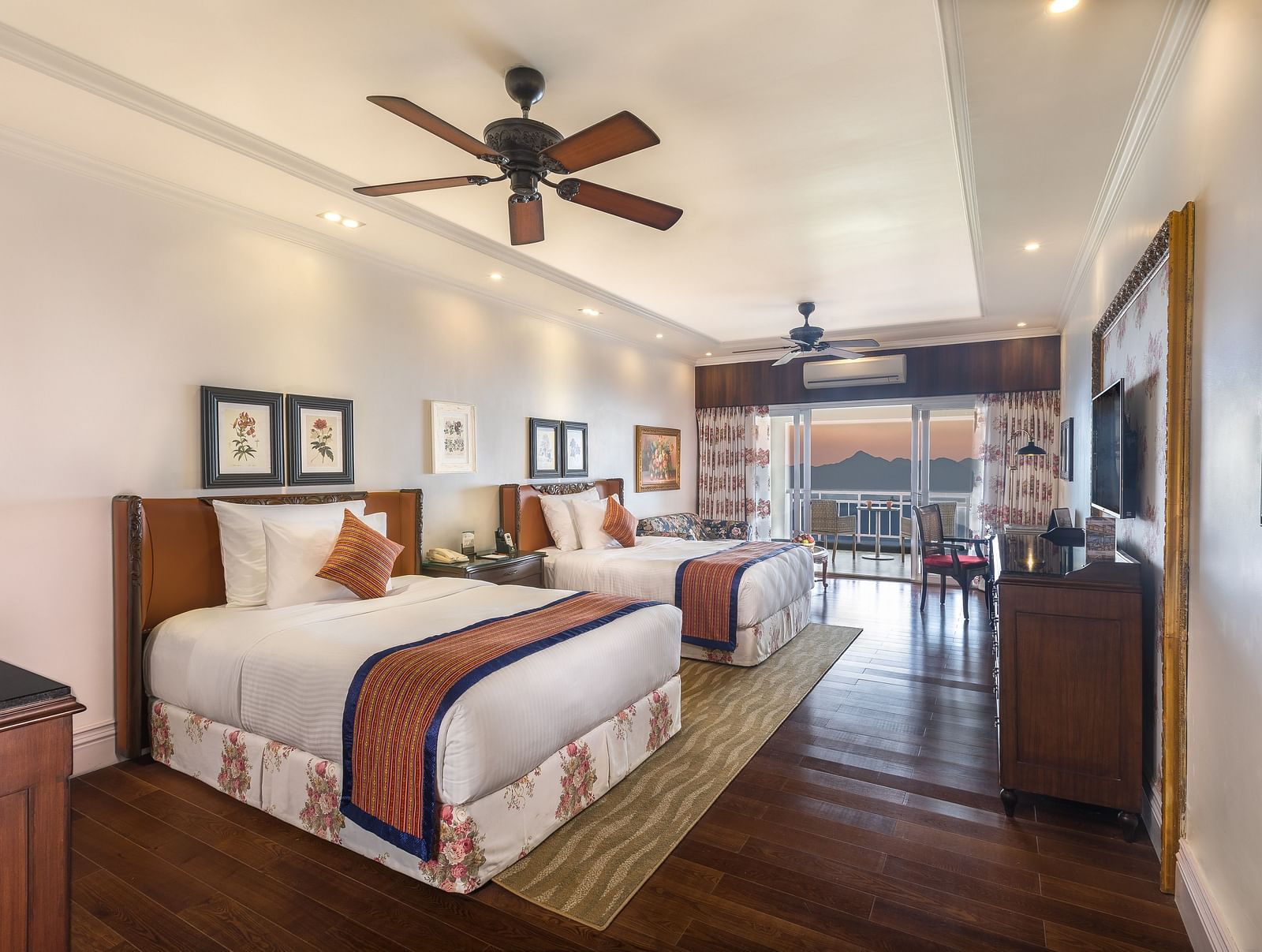 twin beds facing the TV and a wooden cabinet - Mayfair Himalayan Spa Resort Kalimpong