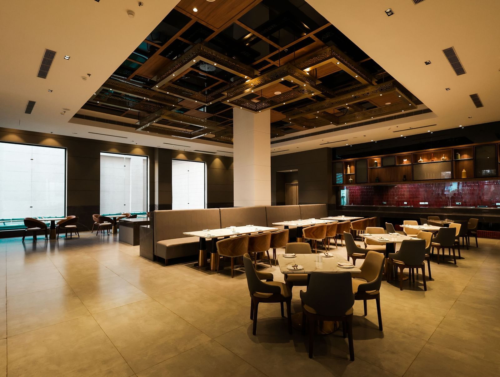 Warmly lit restaurant with elegant ceiling design at Ramada by Wyndham Sonipat Murthal