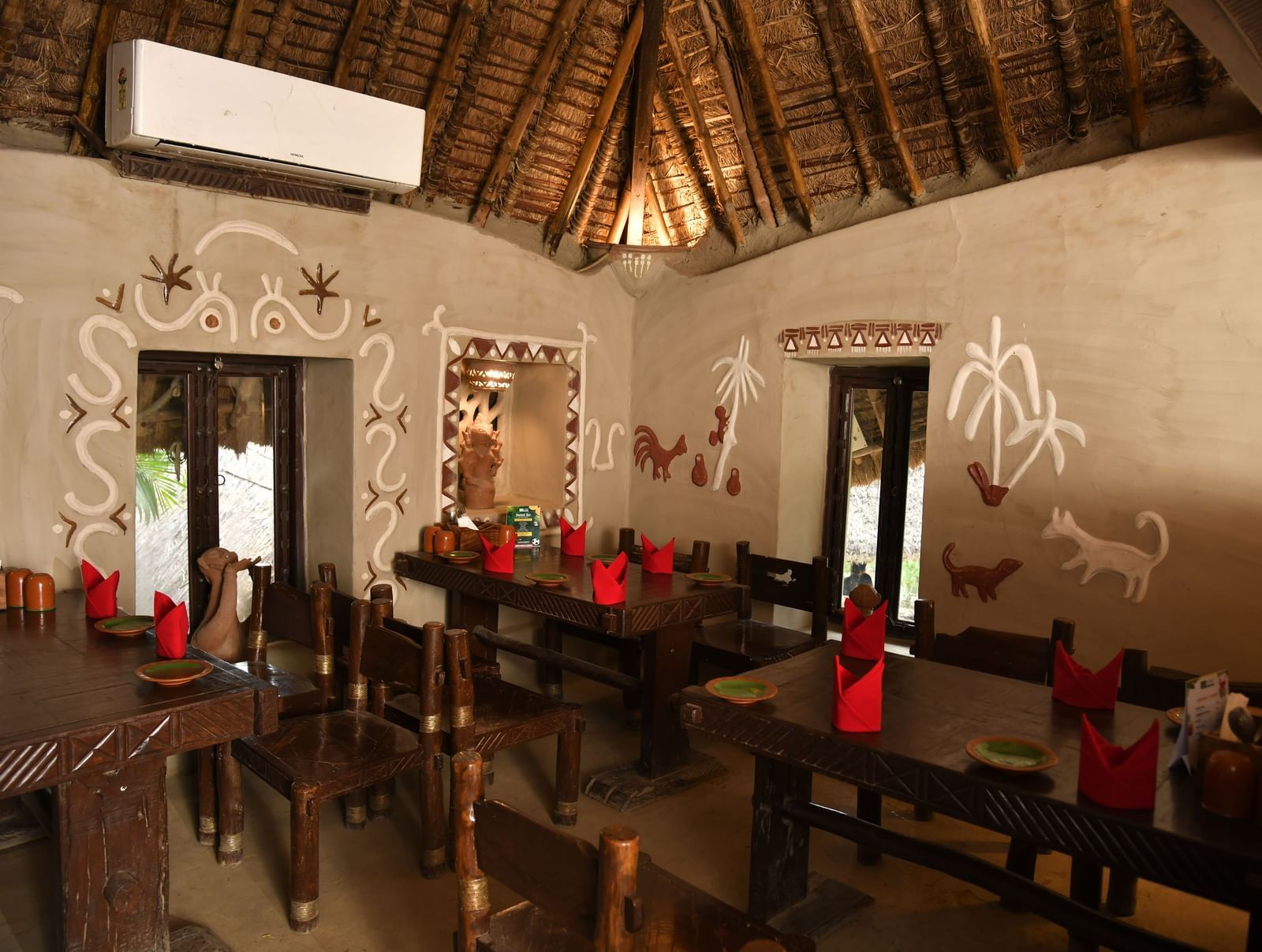 A broader perspective of the restaurant dining area, showcasing multiple tables and the distinctive architecture of the space | Bhoomi Restaurant