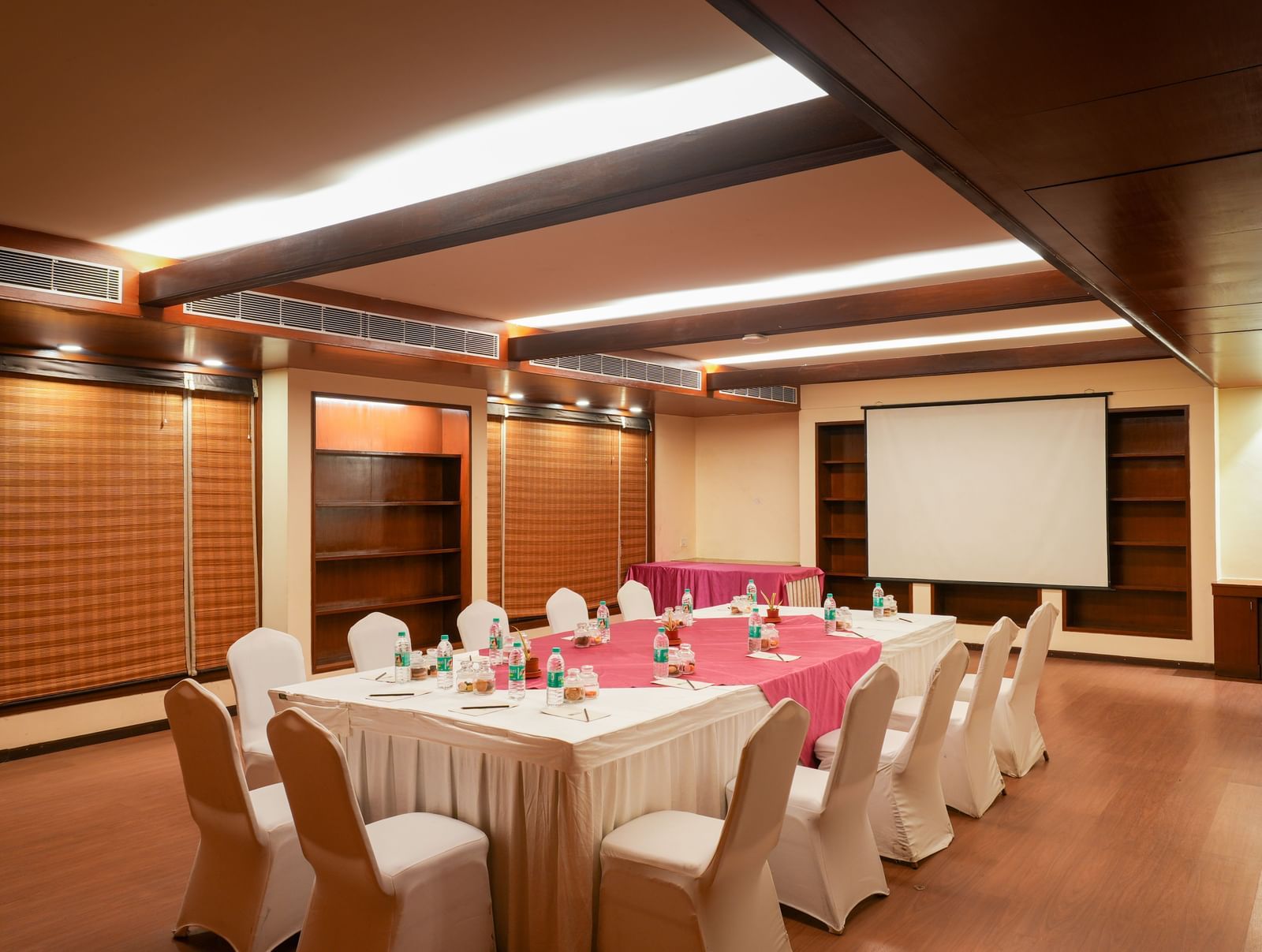 Private boardroom setup with projector screen at Vedic Village Spa Resort.