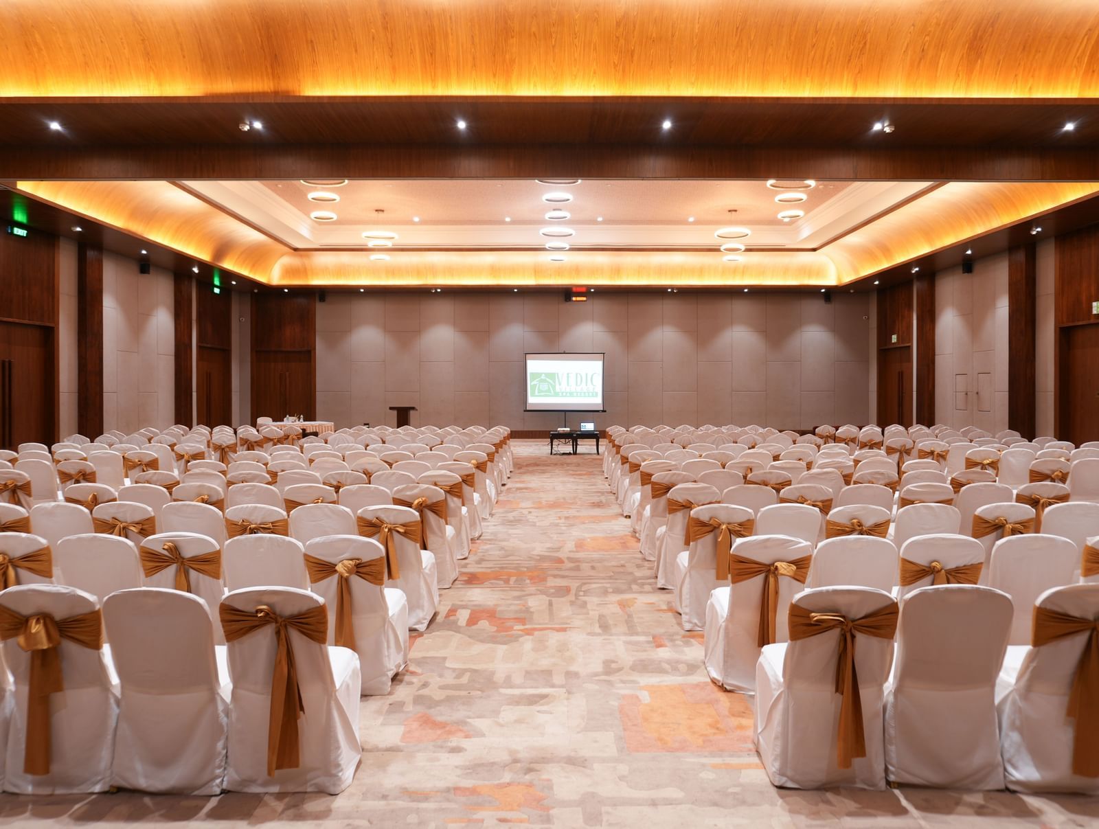 Utsav Convention Centre with classroom-style seating and a presentation screen at Vedic Village Spa Resort.