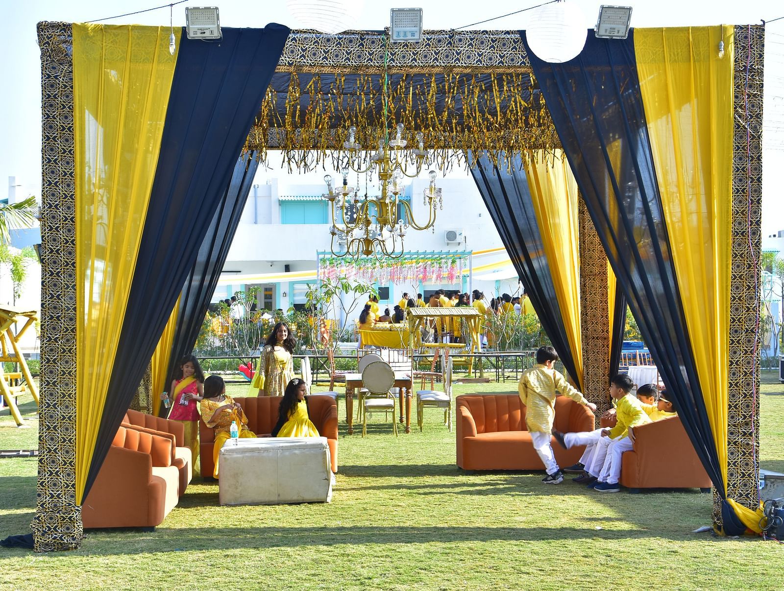Outdoor seating lounge setup for sangeet night at Vedikant Resorts The Mallard Corbett with clear blue sky in the background.