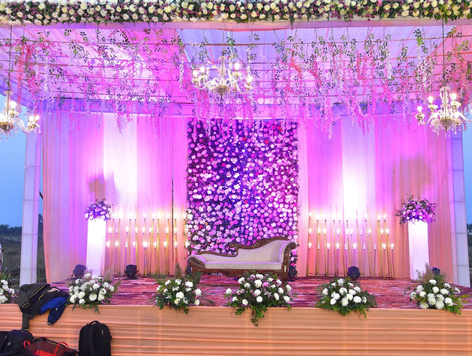 Grand wedding stage with pink floral backdrop at Vedikant Hotels & Resorts.