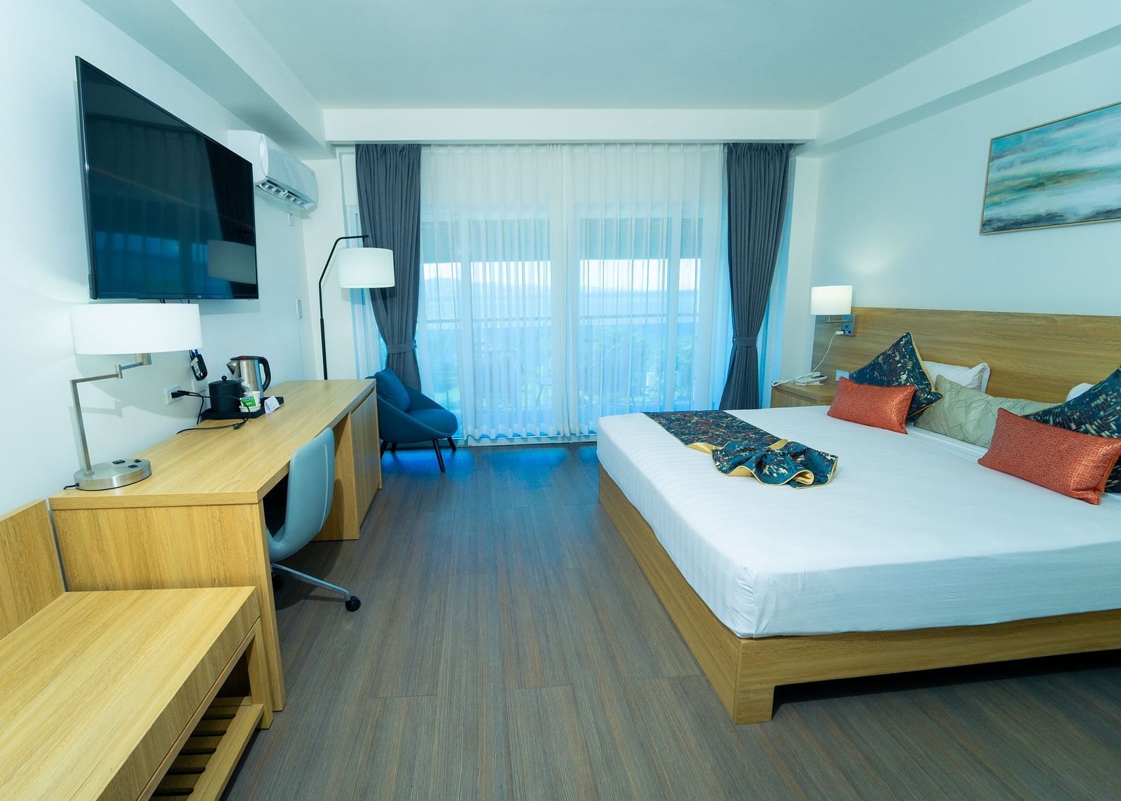 An image of a hotel room in Montego Bay with a king size bed and a wall mounted television - Hotel 39, Jamaica (Montego Bay)