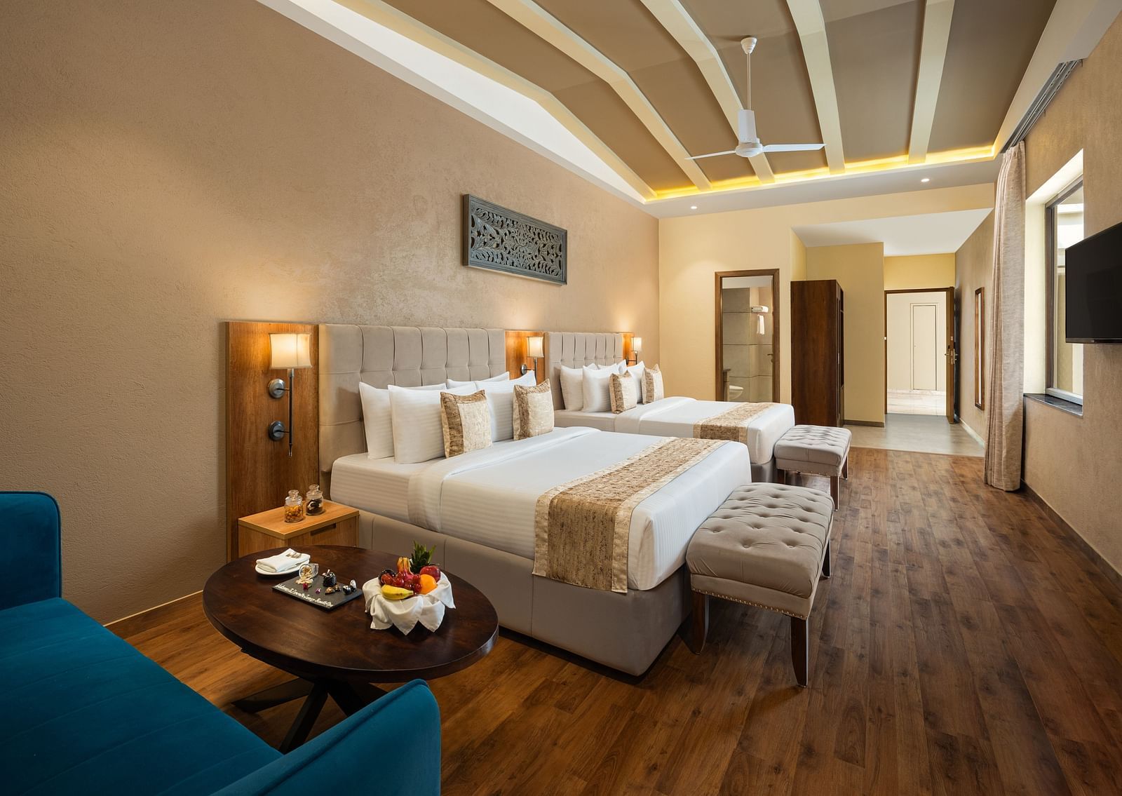 Studio Quad Room with double beds placed in front of TV at Essentia Luxury Resort & Spa, Udaipur.