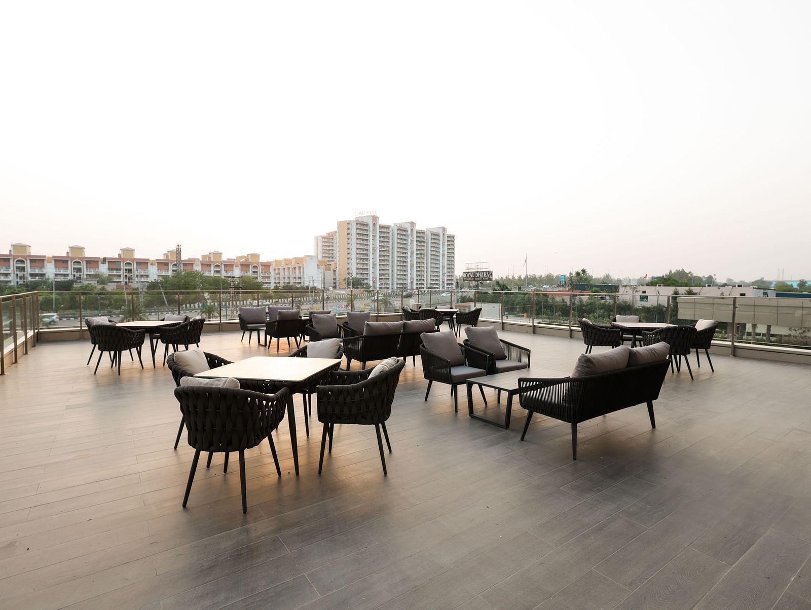 Rooftop seating with city views and modern dining setup at Ramada by Wyndham Sonipat Murthal